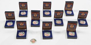Group of Eleven Painted American Eagle Silver Dollars, 2000, ten in original presentation boxes in rigid plastic holders, and one in a rigid plastic h
