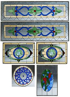 Group of Six Leaded Slag Glass Windows, 20th c., consisting of a rectangular pair with floral decoration; two panels with crossed trumpets; two oval e