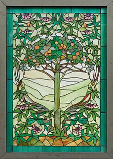 Arts and Crafts Style Leaded Glass Window, 20th c., of a fruit tree in a landscape within a border of purple slag glass rectangles, presented in a woo