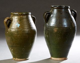 Two French Provincial Green Glazed Earthenware Baluster Oil Jars, each with two ring handles. Taller- H.- 15 in., W.- 10 in., Dia.- 9 in. Provenance: 