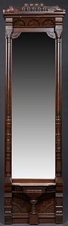 American Carved Walnut Pier Mirror, 19th c., with a rounded and leaf crest, over a recessed arched frieze above a shaped mirror plate, flanked by turn