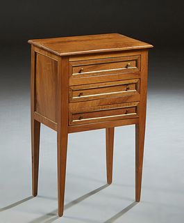 French Louis XVI Style Ormolu Mounted Carved Walnut Nightstand, 20th c., the ogee edge stepped top over a bank of three drawers, on tapered square leg