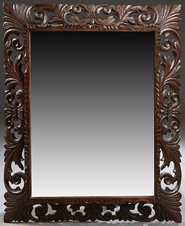 French Henri II Style Carved Walnut Cushion Mirror, c. 1880, with a pierced leaf carved frame around a wide beveled rectangular plate, H.- 44 1/2 in.,