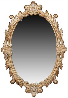 Contemporary Antique Style Carved Giltwood Overmantel Mirror, 20th/21st c., the thick leaf and scroll carved frame around an oval plate, H.- 45 in., W