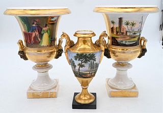 Three French Porcelain Urns, to include a campana form pair having painted and gilt gold landscape on one side and interior scene on the other side, h