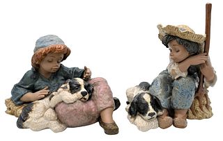 Two Large Lladro Porcelain Figurines, both boy with a dog, one with repair, heights 8 1/2 and 12 1/2 inches.