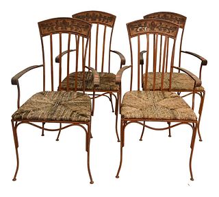 Set of Four Iron Outdoor Armchairs, having rush seats.