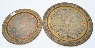 Two Islamic Middle Eastern Chargers, brass with silver and copper inlays, diameters 12 and 15 1/4 inches.