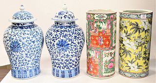 Four Chinese Porcelain Pieces, to include a pair of blue and white jars with scrolling vines and flowers, height 20 inches; a rose medallion umbrella 