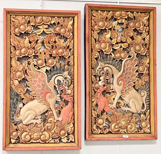 Pair of Chinese Carved Wood Plaques, having painted and carved foo dog amongst gilt flowers, Tepper Galleries tag, 38 1/2 x 28 1/2 inches.