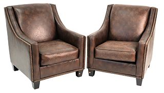 Pair of Brown Leather Armchairs, having large brass tacks, height 38 inches, width 32 inches.