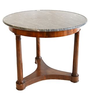 Empire Round Table, on three legs, having grey marble top, height 29 inches, diameter 35 inches, (chips on frieze and edges).