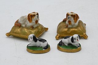 Two Pairs of Miniature Porcelain Dog Figures, to include a pair of Royal Worcester miniature porcelain figures of a dog on a pillow, along with a pair