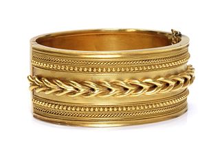 A cased Victorian gold archaeological revival, Etruscan style hinged bangle, c.1860,
