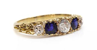 A five stone diamond and sapphire carved head style ring,