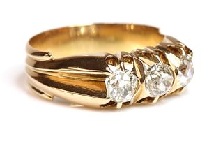 An Edwardian rose gold three stone diamond ring, c.1905,