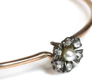 An Edwardian seed pearl and diamond flowerhead bangle,