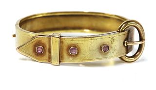 A late Victorian gold jarretière style pink sapphire set bangle,