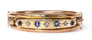 An Edwardian diamond and sapphire hinged bangle, c.1920,