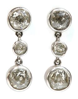 A pair of three stone diamond drop earrings,