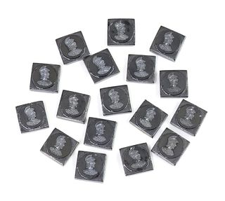 Seventeen square grey or imitation haematite glass intaglio plaques,