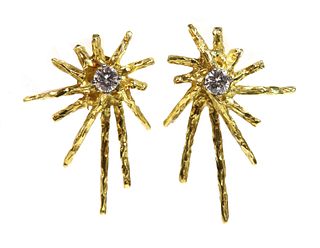 A pair of 18ct gold single stone diamond starburst earrings,