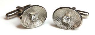 A pair of single stone diamond set cufflinks,