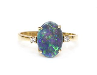 A three stone black opal and diamond ring,