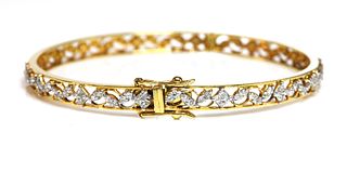 An 18ct gold diamond set hinged bangle,