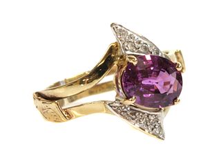 A gold single stone pink sapphire and diamond crossover ring,