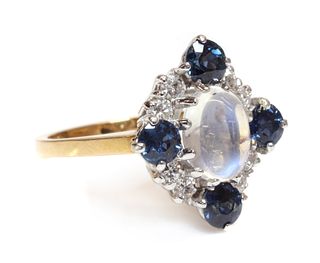 An 18ct gold moonstone, sapphire and diamond, lozenge shaped cluster ring, c.1970,