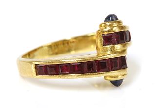A gold ruby and sapphire crossover ring,