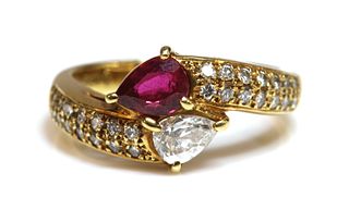 A gold ruby and diamond crossover ring,