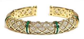 An emerald and diamond sprung torque bangle,