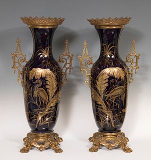 Pair of Vases; France, Napoleon III, nineteenth century. 
Gilt bronze and enameled earthenware SevrÃ©s Bleu du Roi style and gilt,
