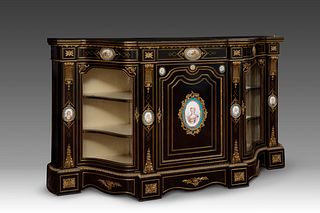 Napoleon III style credenza, circa 1870. 
Ebonized wood, porcelain plates and bronze sconces. 
It presents restorations in the central plate and the k
