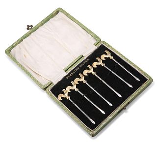 A SET OF SIX STERLING SILVER COCKTAIL STICKS, each with gilded cockerel ter