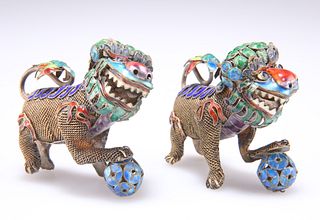 A PAIR OF CHINESE SILVER AND ENAMEL MODELS OF BUDDHIST LIONS, early 20th Ce
