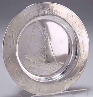 A STERLING SILVER DISH, probably American, circular, engraved with a boat a