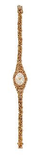 A LADY'S 18 CARAT GOLD TEWOR BRACELET WATCH, oval silver dial with baton in