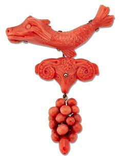 AN ITALIAN CORAL BROOCH, carved depicting a sea dragon suspending a rams he