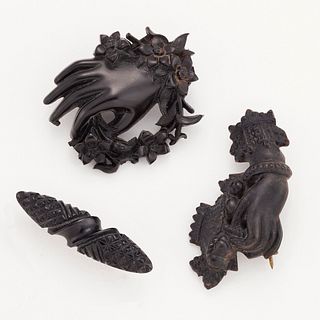 THREE VICTORIAN BROOCHES, including A VULCANITE BROOCH, modelled as a hand 