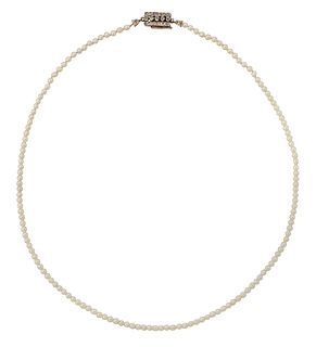 A PEARL NECKLACE WITH A DIAMOND-SET CLASP, a strand of uniform pearls to a 