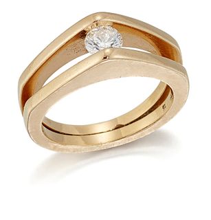 A SOLITAIRE DIAMOND RING, a round brilliant-cut diamond in a tension settin