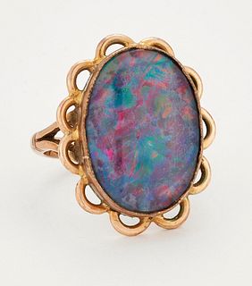 A COMPOSITE OPAL RING, an oval composite opal in a bezel setting within a p