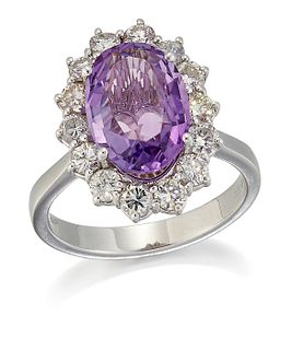 AN 18 CARAT WHITE GOLD AMETHYST AND DIAMOND CLUSTER RING, an oval-cut ameth
