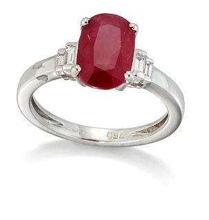 AN 18 CARAT WHITE GOLD RUBY AND DIAMOND RING, an oval-cut ruby between grad