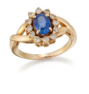 A SAPPHIRE AND DIAMOND CLUSTER RING, an oval-cut sapphire in a claw setting