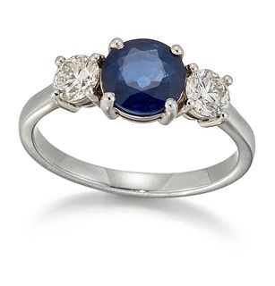 A SAPPHIRE AND DIAMOND THREE STONE RING, a round-cut sapphire spaced by rou