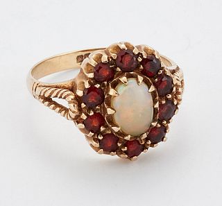 A 9 CARAT GOLD OPAL AND DIAMOND CLUSTER RING, an oval opal within a border 